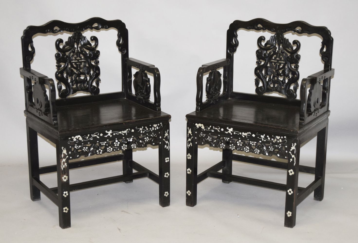 A GOOD PAIR OF CHINESE CARVED HARDWOOD CHAIRS, inlaid with mother of pearl