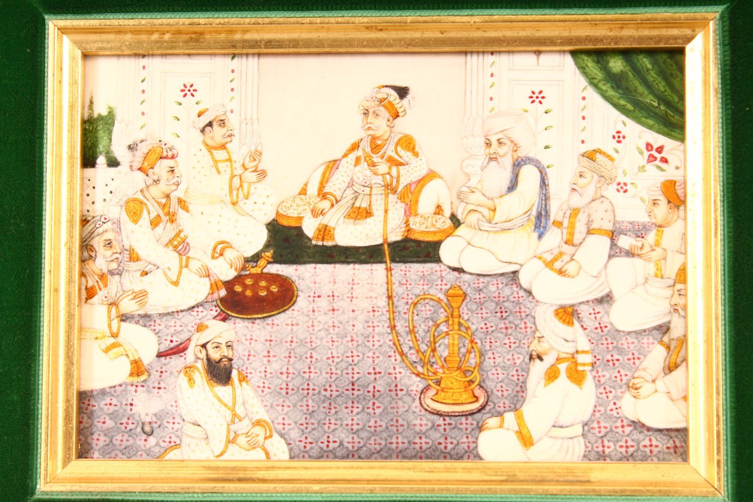 AN INDIAN MINIATURE PAINTING ON BONE OR IVORY - depicting male figures seated around a pipe - framed - Image 2 of 3