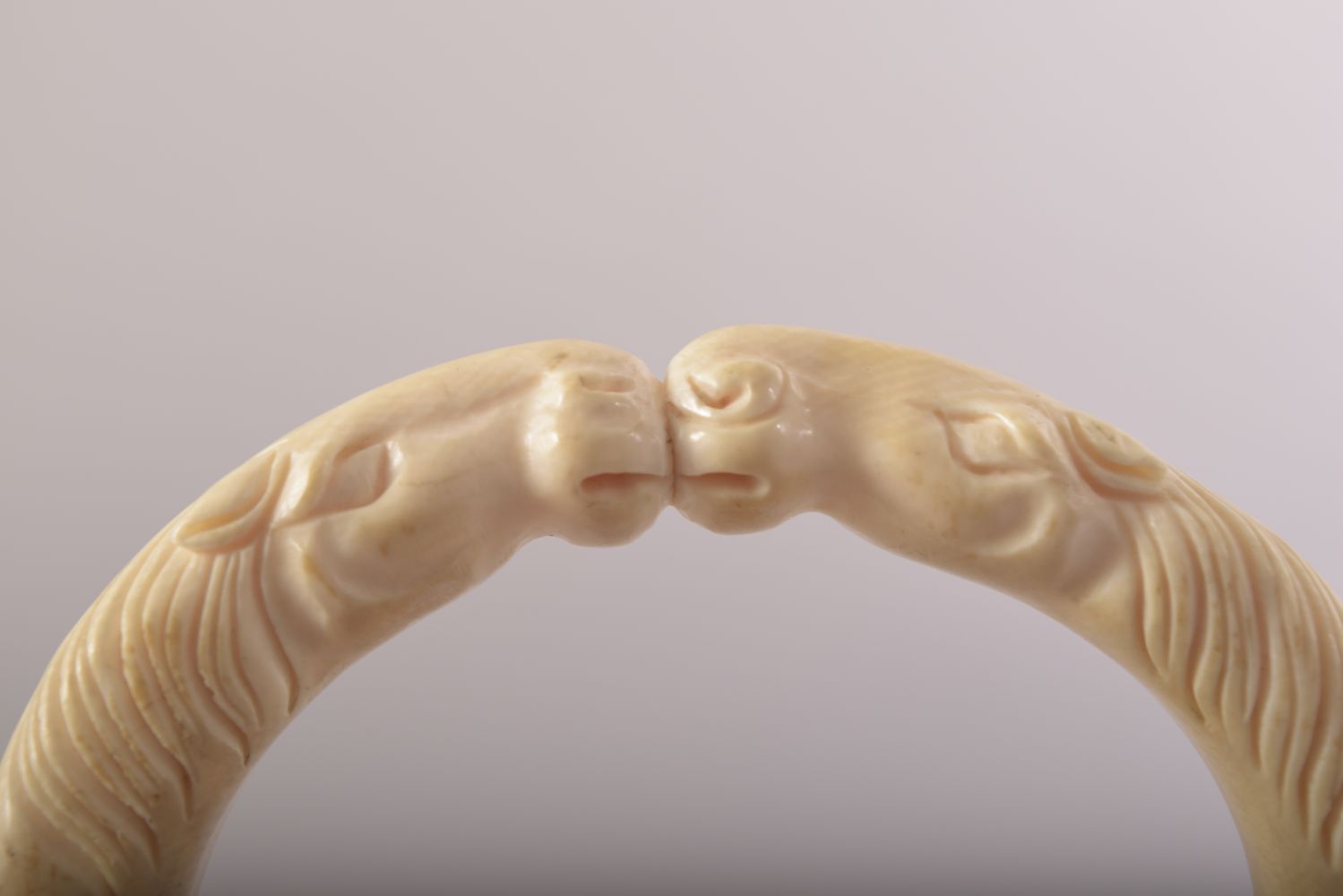 A CARVED BONE BANGLE with horses, 9.5cm x 8cm. - Image 3 of 4