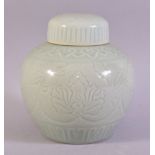 A GOOD CHINESE CELADON PORCELAIN JAR AND COVER, with incised floral decoration under glaze, 19.5cm
