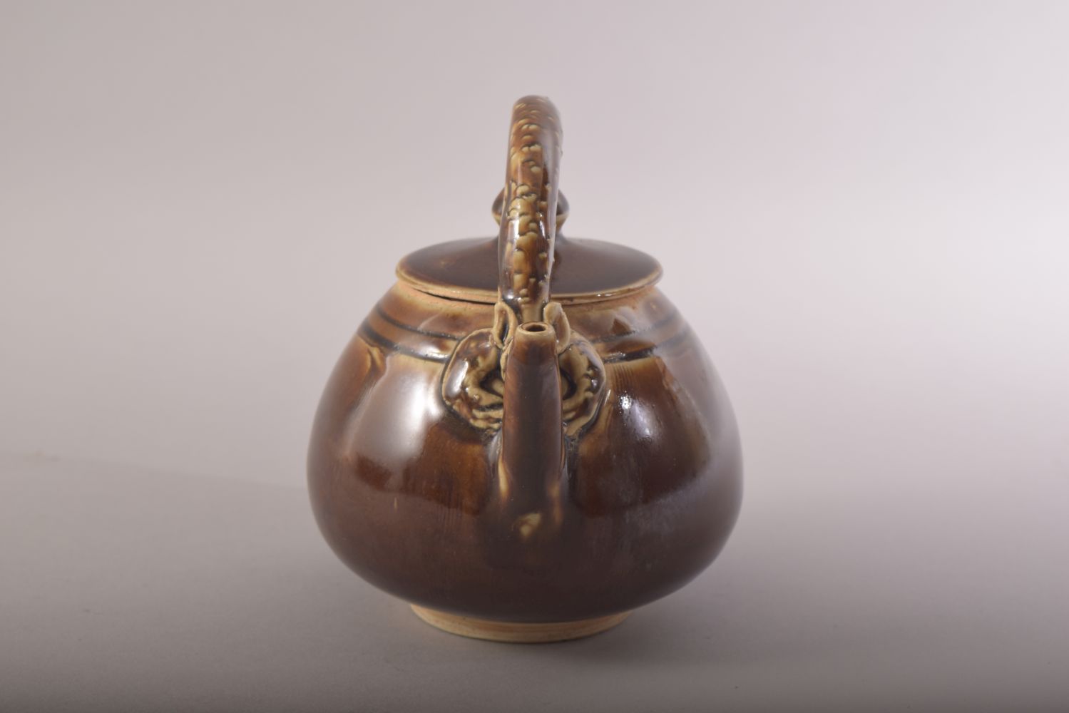 A SMALL CHINESE TREACLE GLAZE TEAPOT, with a chilong type handle, 13.5cm high. - Image 2 of 8