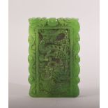 A CHINESE CARVED JADEITE PENDANT, carved with dragon to one side, phoenix to reverse, 9cm x 5.5cm.