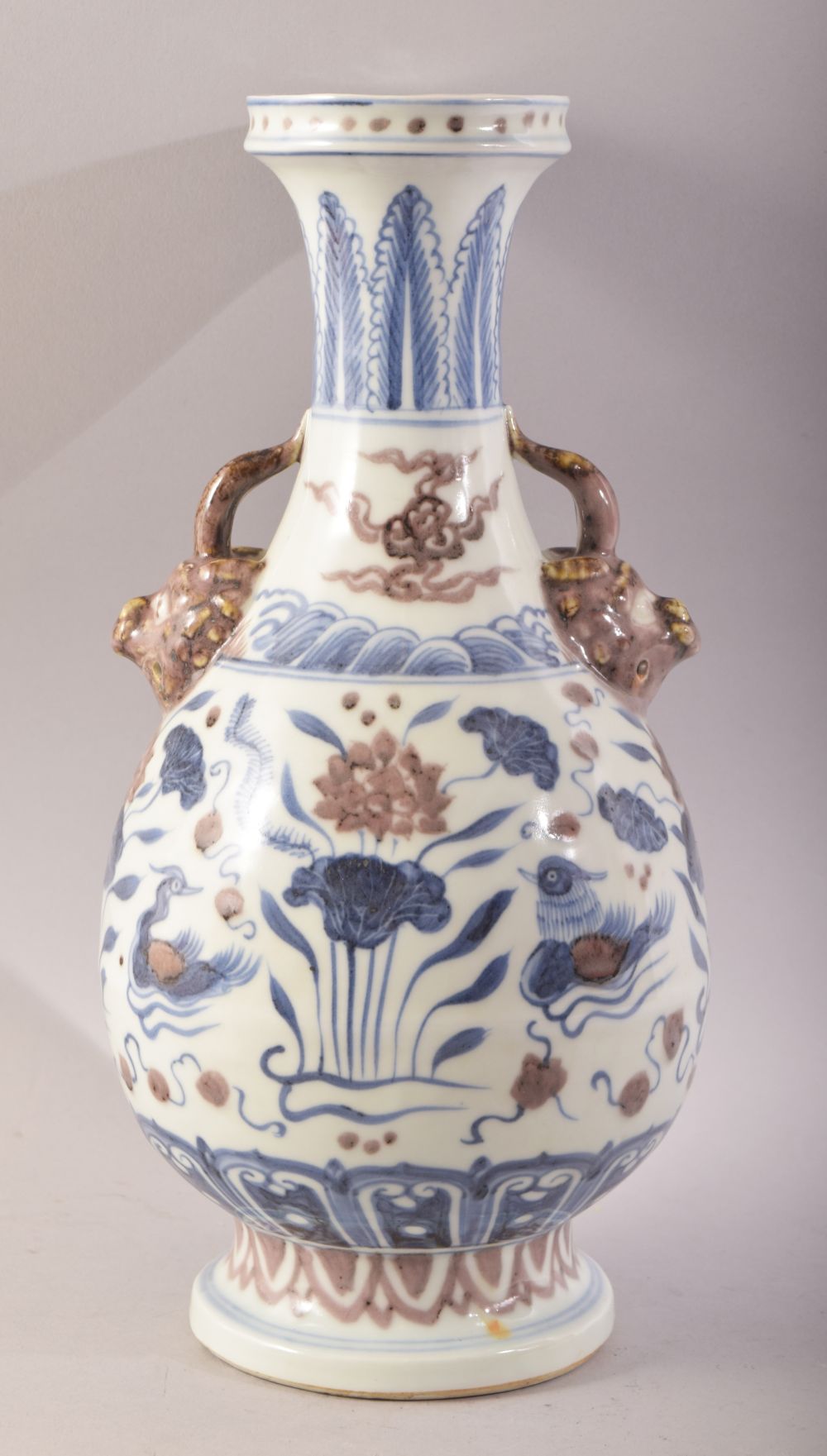 A CHINESE BLUE, WHITE & IRON RED TWIN HANDLE PORCELAIN VASE - th body decorated with duck and lotus,