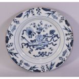 A CHINESE BLUE AND WHITE PORCELAIN DISH, the centre painted with an urn of flowers and scroll as
