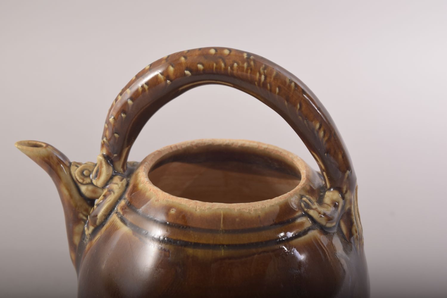 A SMALL CHINESE TREACLE GLAZE TEAPOT, with a chilong type handle, 13.5cm high. - Image 7 of 8