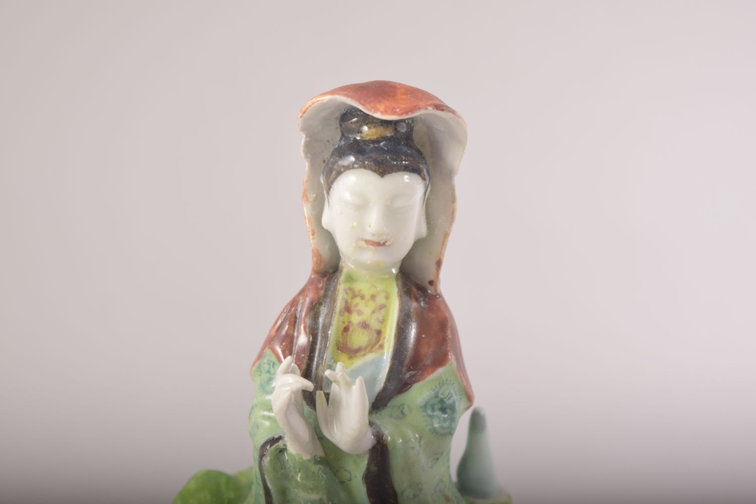 A SMALL CHINESE PORCELAIN FIGURE OF A FEMALE amongst lilies, 13cm high. - Image 5 of 7