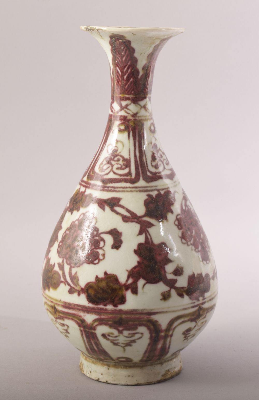 A CHINESE IRON RED AND WHITE GLAZED POTTERY VASE, decorated with floral motifs, 24.5cm high.