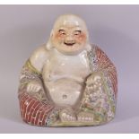 A CHINESE FAMILLE ROSE PORCELAIN FIGURE OF BUDDHA, with impressed mark to base, 23cm high.