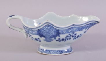 A CHINESE BLUE AND WHITE PORCELAIN SAUCE BOAT, the interior decorated with native flora, 21.5cm