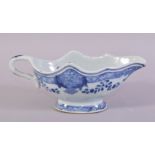 A CHINESE BLUE AND WHITE PORCELAIN SAUCE BOAT, the interior decorated with native flora, 21.5cm