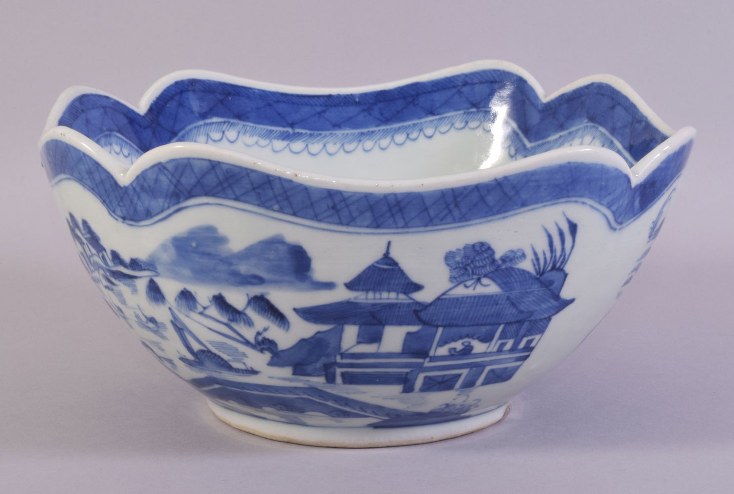 A CHINESE BLUE AND WHITE PORCELAIN BOWL, decorated with a landscape including buildings, boats and