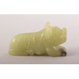 A SMALL CHINESE CARVED JADE FIGURE OF A BEAST, 6cm long.