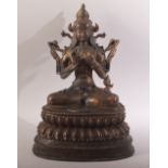 A TIBETAN GILT COPPER ALLOY FIGURE OFF BUDDHA / GREEN TARA - seated upon a lotus base - sat in