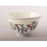 A CHINESE PORCELAIN DOUCAI CUP, painted with birds and peach blossom, six character mark to base,