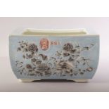 A CHINESE BLUE GROUND RECTANGULAR PORCELAIN PLANTER, decorated with flowers in grey and script, four