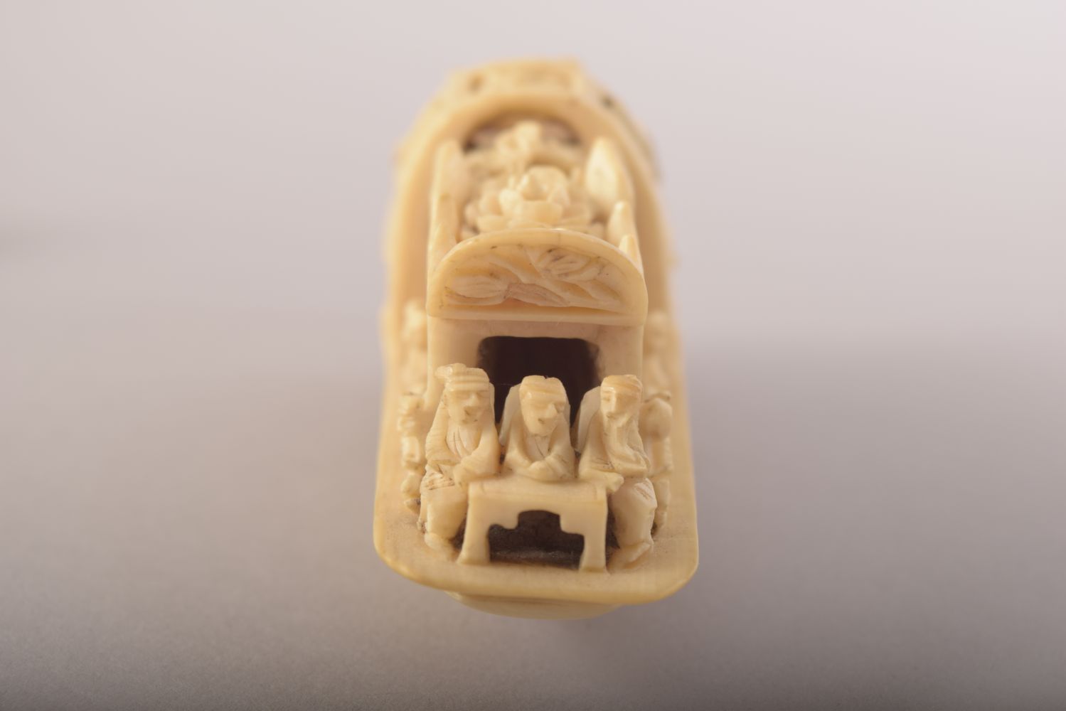 A SMALL CARVED IVORY MODEL OF A JUNK and wooden stand, 8cm long. - Image 3 of 8