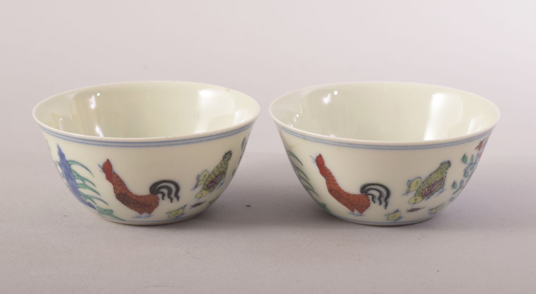 TWO GOOD CHINESE PORCELAIN ROOSTER CUPS, painted with roosters, chicks and flora, both with six