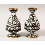 A PAIR OF ISLAMIC BLACK GROUND ENAMEL VASES, each decorated with a black ground and white raised