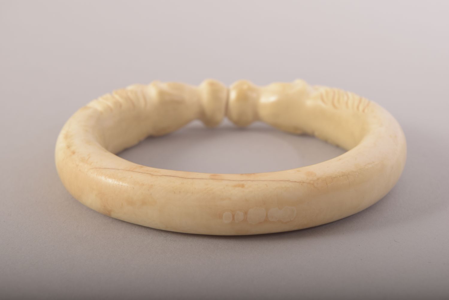 A CARVED BONE BANGLE with horses, 9.5cm x 8cm. - Image 4 of 4