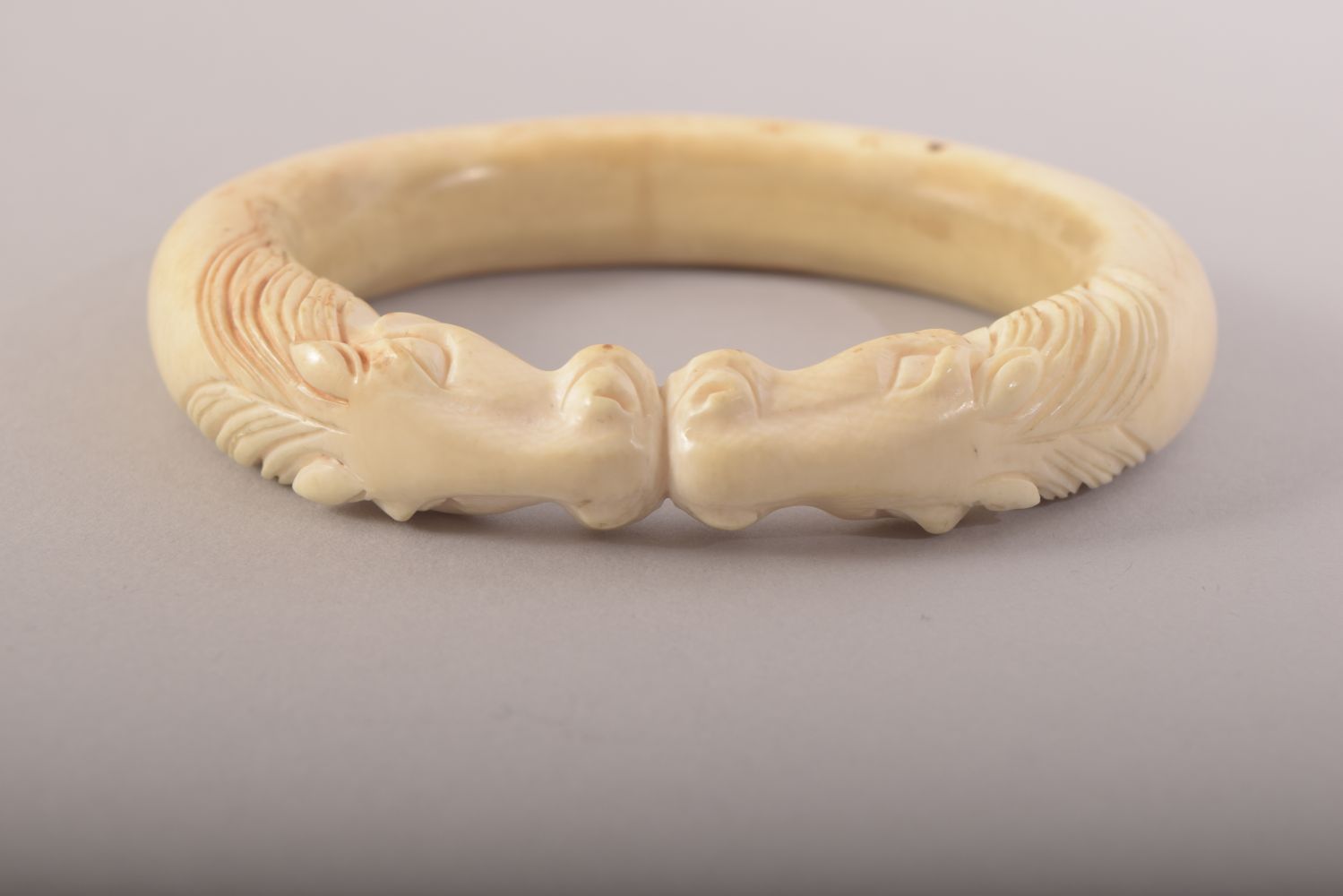 A CARVED BONE BANGLE with horses, 9.5cm x 8cm. - Image 2 of 4