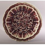 A CHINESE OX BLOOD / FLAMBE MING STYLE PORCELAIN DRAGON DISH - the underside with raised mark to rim