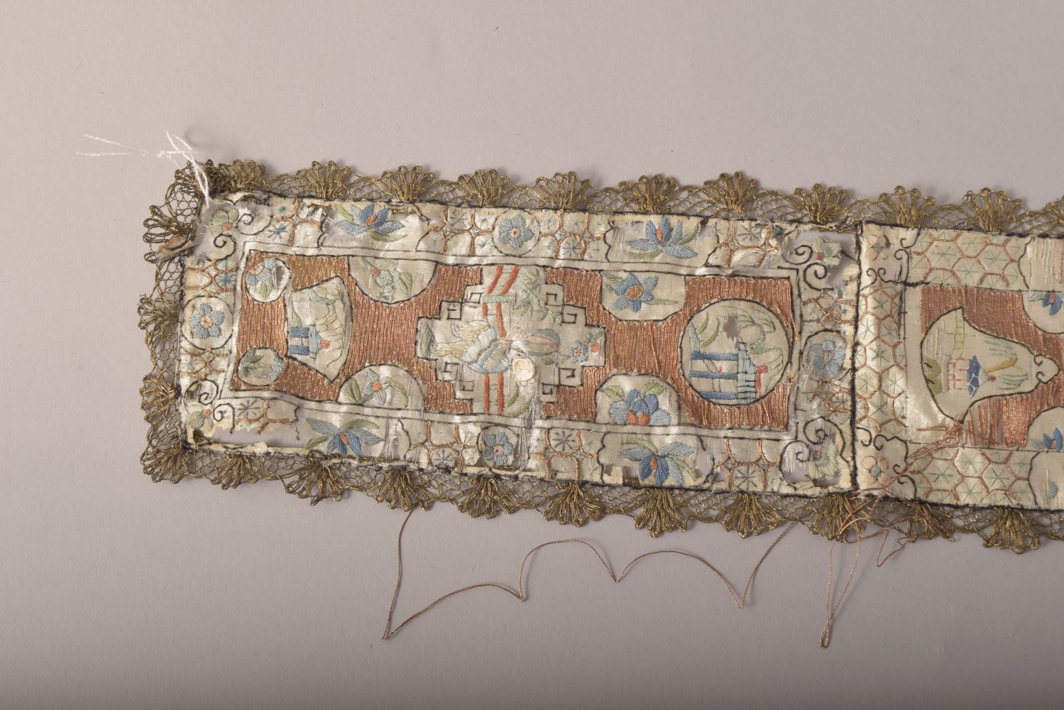 A CHINESE EMBROIDERED SILK TEXTILE, embroidered with various panels of figures, 96cm long. - Image 5 of 5