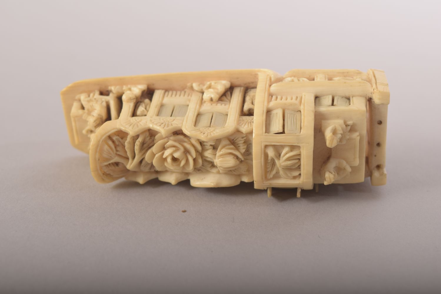 A SMALL CARVED IVORY MODEL OF A JUNK and wooden stand, 8cm long. - Image 6 of 8