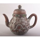 A CHINESE YIXING TEAPOT, with metal mounts and inlaid rim, impressed mark to metal base, 15cm high.