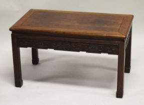 A CHINESE HARDWOOD RECTANGULAR TABLE, with carved frieze and supported on four scroll feet, 47cm