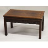 A CHINESE HARDWOOD RECTANGULAR TABLE, with carved frieze and supported on four scroll feet, 47cm
