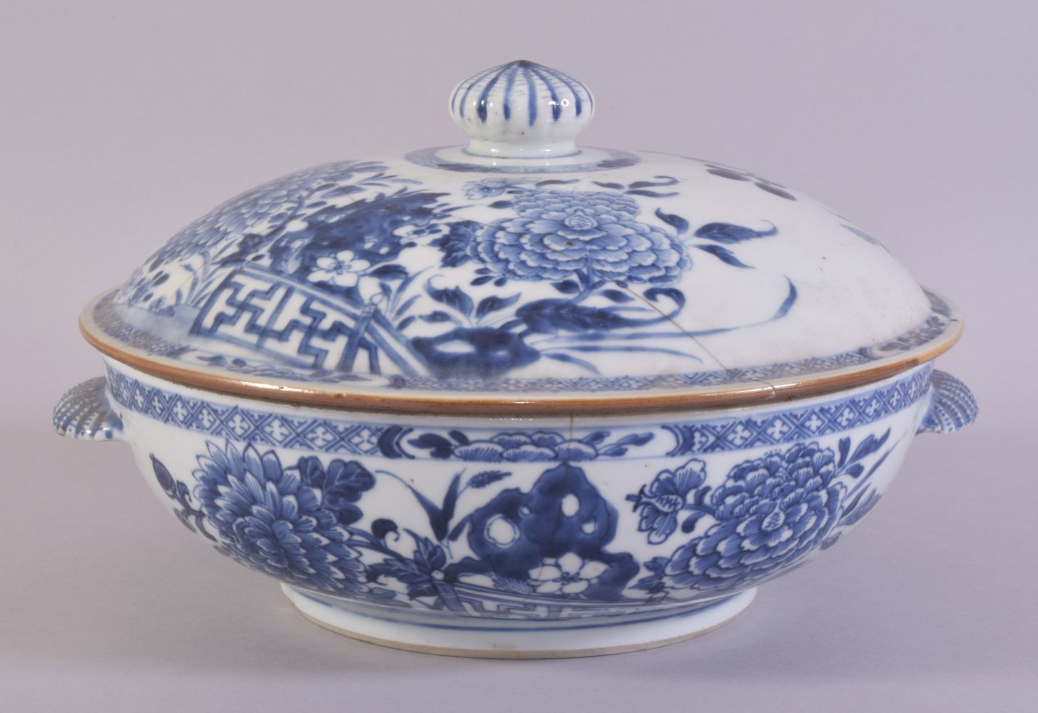 A CHINESE BLUE AND WHITE PORCELAIN CIRCULAR TUREEN AND COVER, painted with native flora, the
