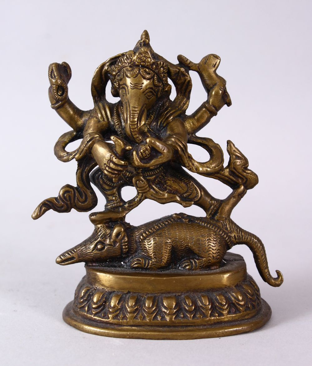 A SMALL INDIAN BRONZE FIGURE OF GANESH UPON BEAST, upon a stylized base, holding many implements.