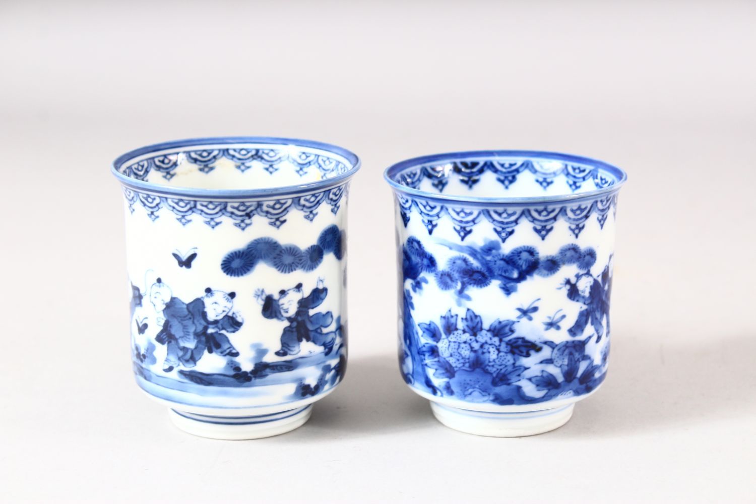 A NEAR PAIR OF JAPANESE BLUE AND WHITE PORCELAIN CUPS, decorated with boys in a landscape, 7.5cm and - Image 4 of 8