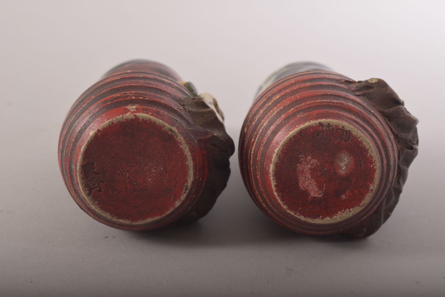 AN UNUSUAL PAIR OF SMALL JAPANESE FIGURAL POTTERY VASES, the rim and neck glazed, with two moulded - Image 6 of 6