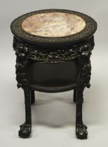 A CHINESE CARVED HARDWOOD MARBLE TOP TWO TIER STAND, the frieze carved with foliate decoration,