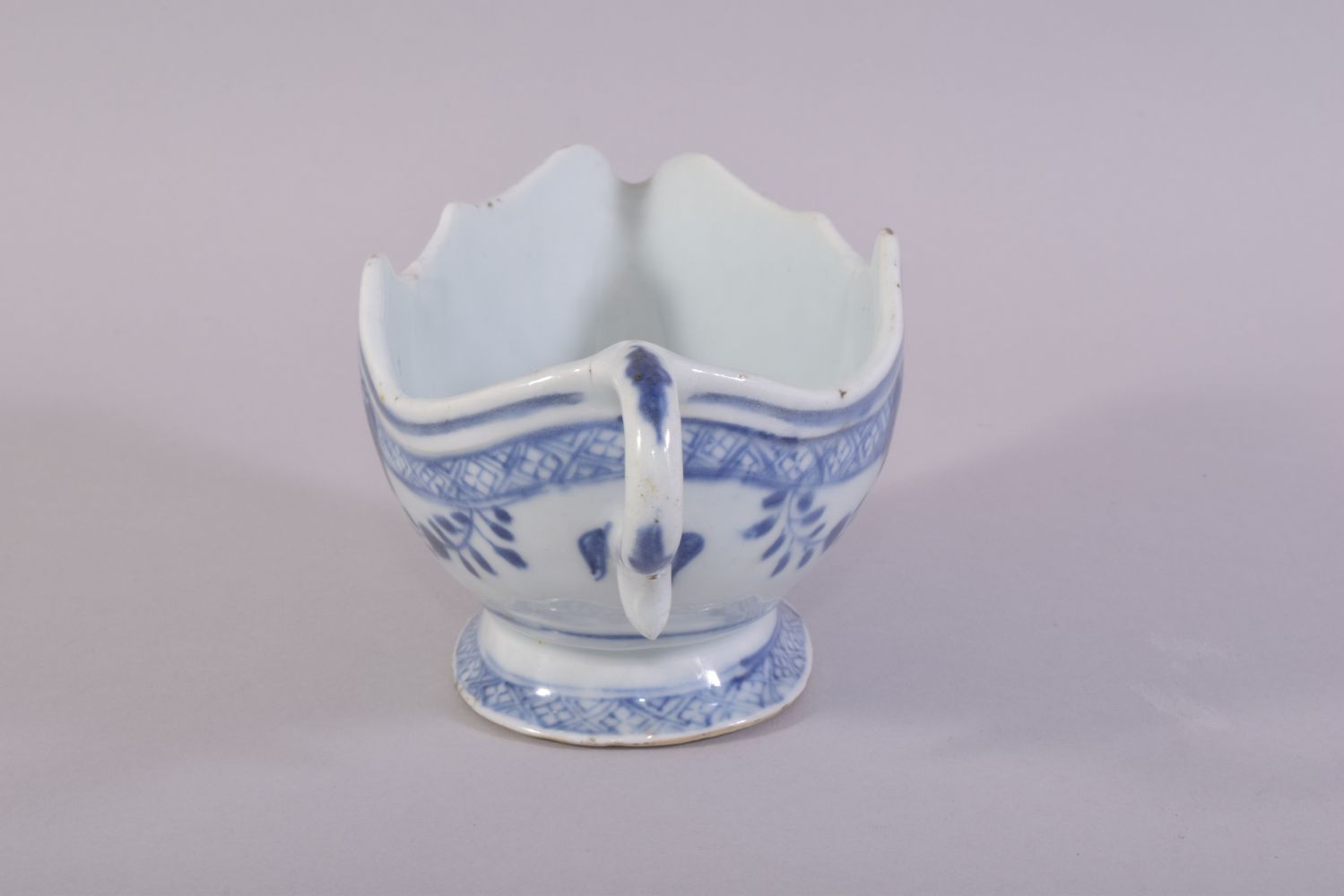 A CHINESE BLUE AND WHITE PORCELAIN SAUCE BOAT, the interior decorated with native flora, 21.5cm - Image 4 of 6