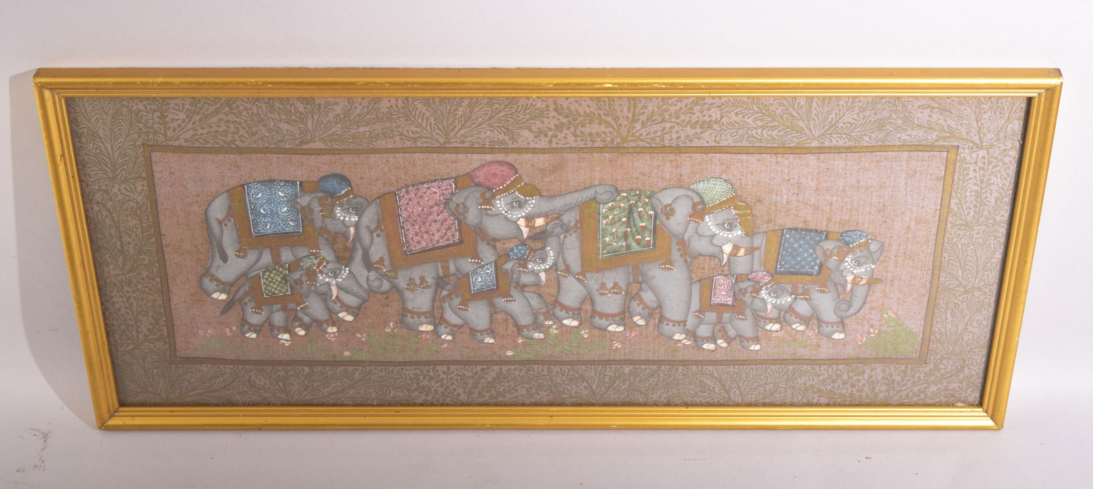 AN INDIAN PAINTING OF ELEPHANTS ON SILK, framed and glazed, 23cm x 53cm.