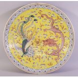 A LARGE CHINESE FAMILLE JAUNE PORCELAIN DISH, the centre painted with dragon, phoenix and the