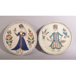 A PAIR OF TURKISH KUTAHYA PLATES, painted with a male and female figure and floral sprays, both 16cm