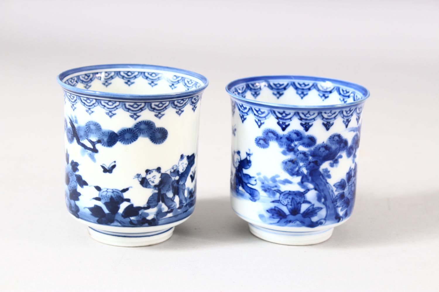 A NEAR PAIR OF JAPANESE BLUE AND WHITE PORCELAIN CUPS, decorated with boys in a landscape, 7.5cm and - Image 3 of 8