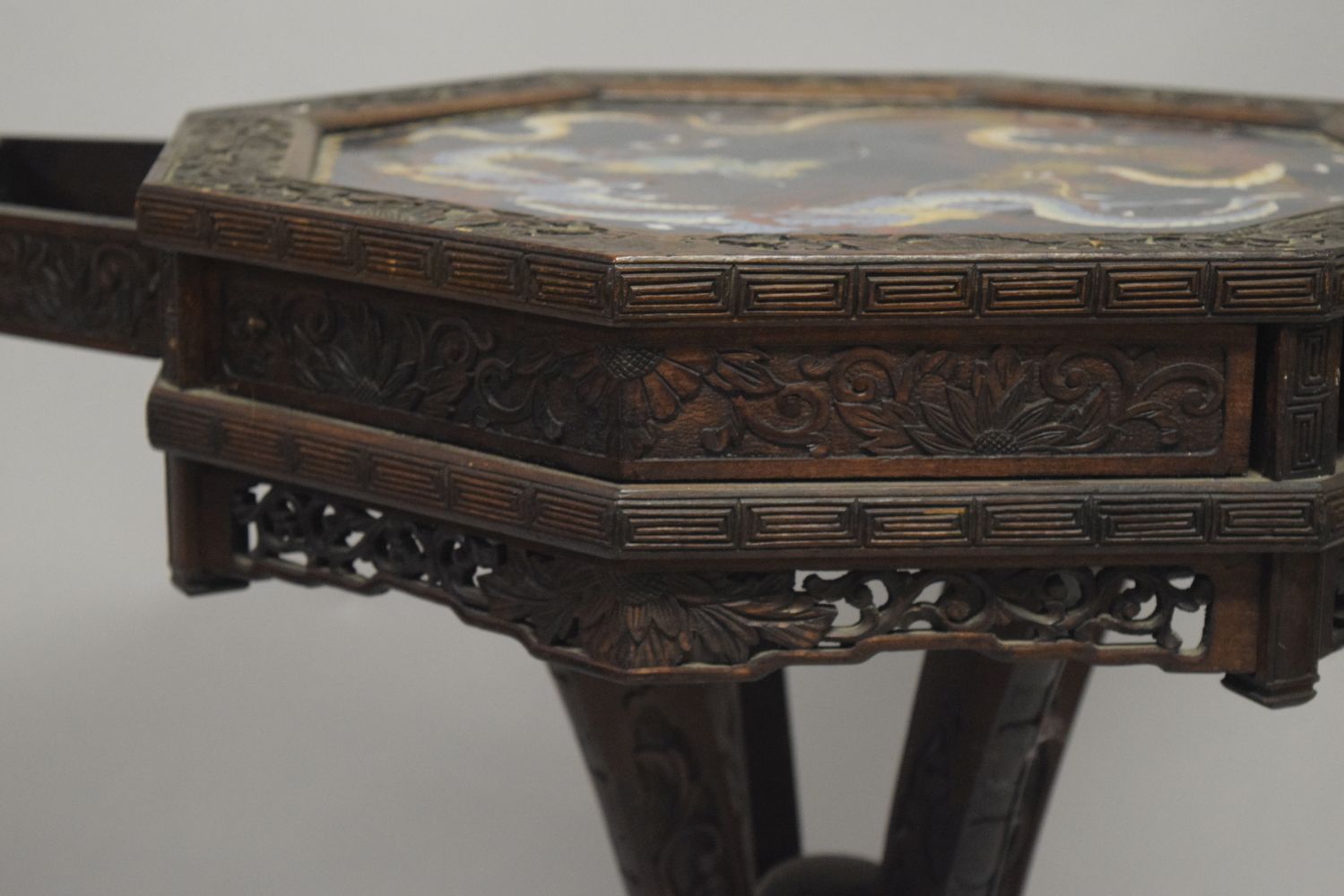 AN UNUSUAL CHINESE OCTAGONAL CARVED HARDWOOD PEDESTAL TABLE, the top inset with a cloissonne panel - Image 7 of 7
