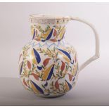 A TURKISH KUTAHYA GLAZED POTTERY WATER JUG, painted with stylised leaves and vine,
