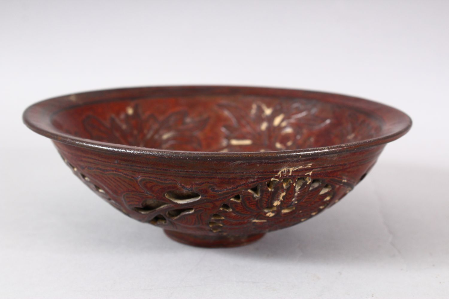 A CHINESE PIERCED POTTERY BOWL - the interior decorated with scenes of flora, the underside with - Image 3 of 6