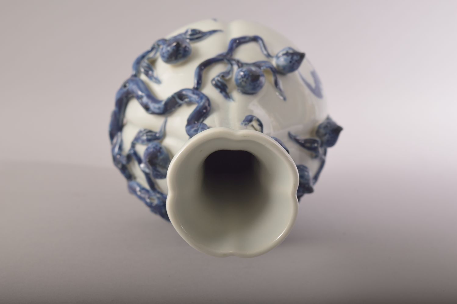 A CHINESE BLUE AND WHITE PORCELAIN VASE, with moulded relief peach tree decoration, the body with - Image 5 of 7
