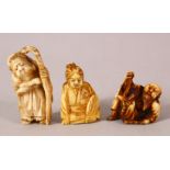 THREE JAPANESE MEIJI PERIOD CARVED IVORY NETSUKE - one depicting a lucky god holding his staff,