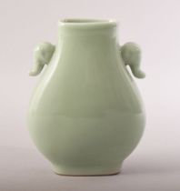 A SMALL CHINESE CELADON GLAZED VASE, with elephant formed handles, impressed mark to base, 15cm