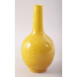 A SMALL CHINESE YELLOW GLAZE PORCELAIN BOTTLE VASE, incised under glaze with dragons and the flaming