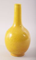 A SMALL CHINESE YELLOW GLAZE PORCELAIN BOTTLE VASE, incised under glaze with dragons and the flaming