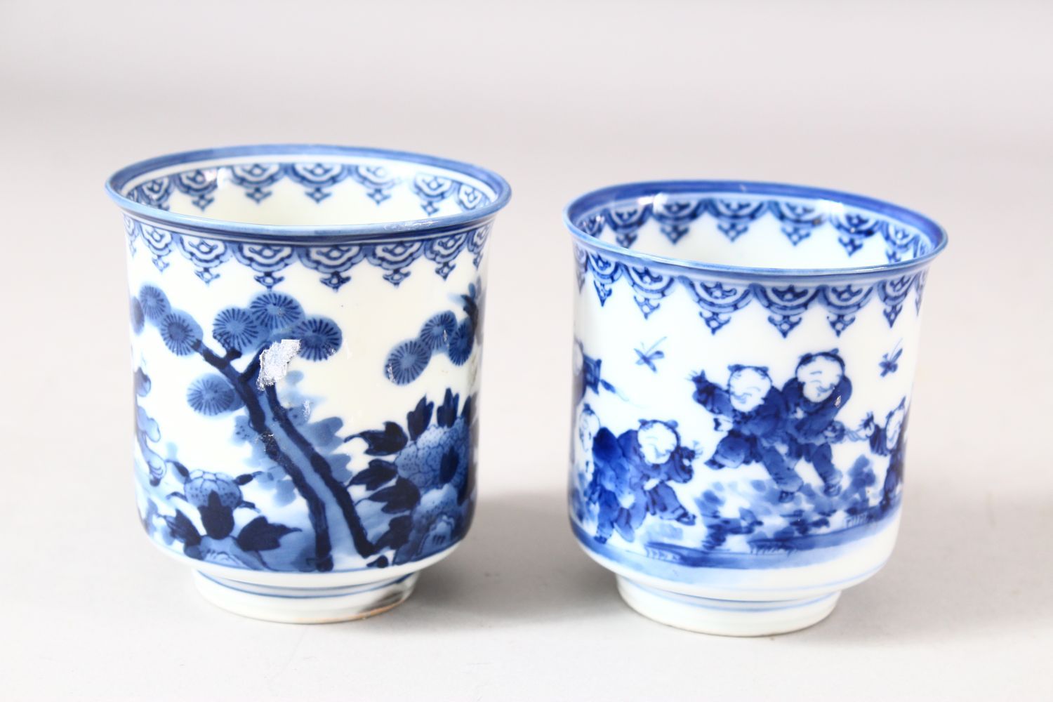 A NEAR PAIR OF JAPANESE BLUE AND WHITE PORCELAIN CUPS, decorated with boys in a landscape, 7.5cm and - Image 2 of 8