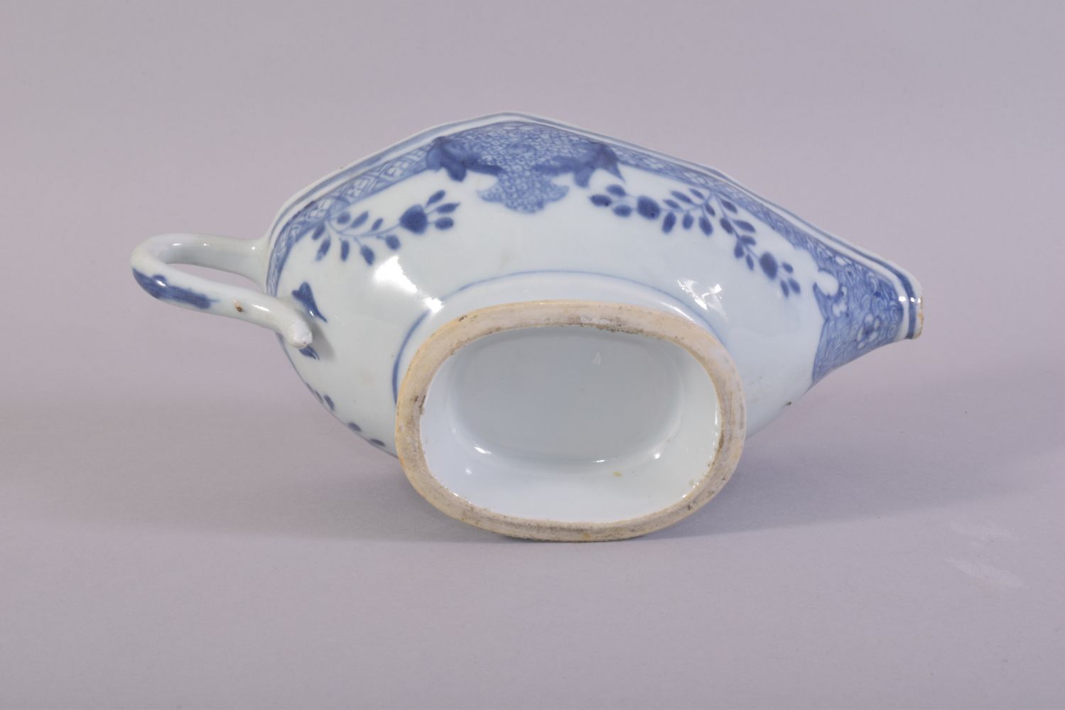 A CHINESE BLUE AND WHITE PORCELAIN SAUCE BOAT, the interior decorated with native flora, 21.5cm - Image 6 of 6